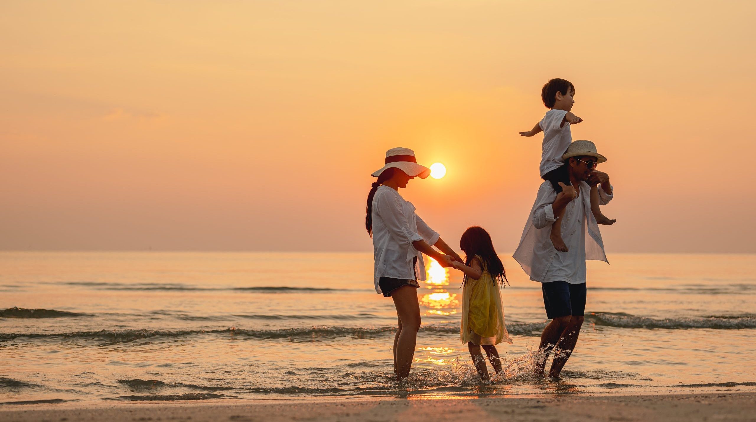 Partner and Family Migration Visas – Reunite in Australia | Beyond Horizons Family walking on beach at sunset representing partner and family visa support through our services.